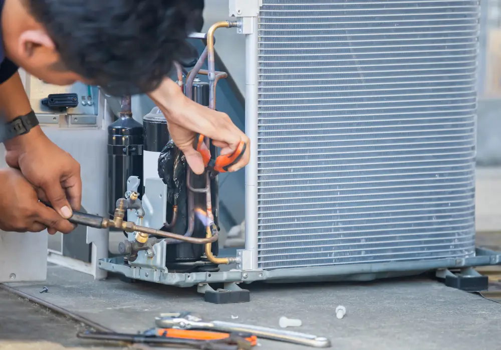 The Benefits of Investing in a High-Efficiency AC Unit to Lower Costs - Repairman fixing HVAC.